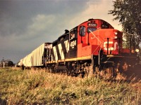 Engineer Dennis Fleet looks back at his train as the crew of the 15:30 Kitchener Job attempts to work ahead and depart Elmira, Ontario on September 11, 1996. The crew is finishing switching at Sulco Chemicals before an approaching super cell descends on the area. CN GP9RM 4124 would soon throttle-up and haul its sizeable train back to Kitchener along the Waterloo Spur eventually being overtaken by the fast moving storm. 