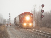 I had just finished shooting Trillium in Port Colborne (a couple of shots <a href="http://www.railpictures.ca/?attachment_id=36923">here</a> and <a href="http://www.railpictures.ca/?attachment_id=36626">here</a>) and was heading back to the Port Rob area when I heard CP TE11 talking to CN RTC. I had no real clue where they were, and was in fact heading somewhere else to look when I happened upon them at CN's Southern Yard (which in hindsight would have been the obvious place to look first) working the interchange. It was a very windy day with snow squalls at times, and here a couple of crew members are caught up in some unpleasant weather as they walk the length of the train to the head end so they can return to Welland Yard. I felt bad for them until I realized I was out standing at the side of the road in the same conditions they were in.