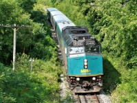 With a friendly wave from the 'second engineer' VIA Rail train 84 rolls through the hamlet of Limehouse and all the summer foliage as it heads east to Toronto. 