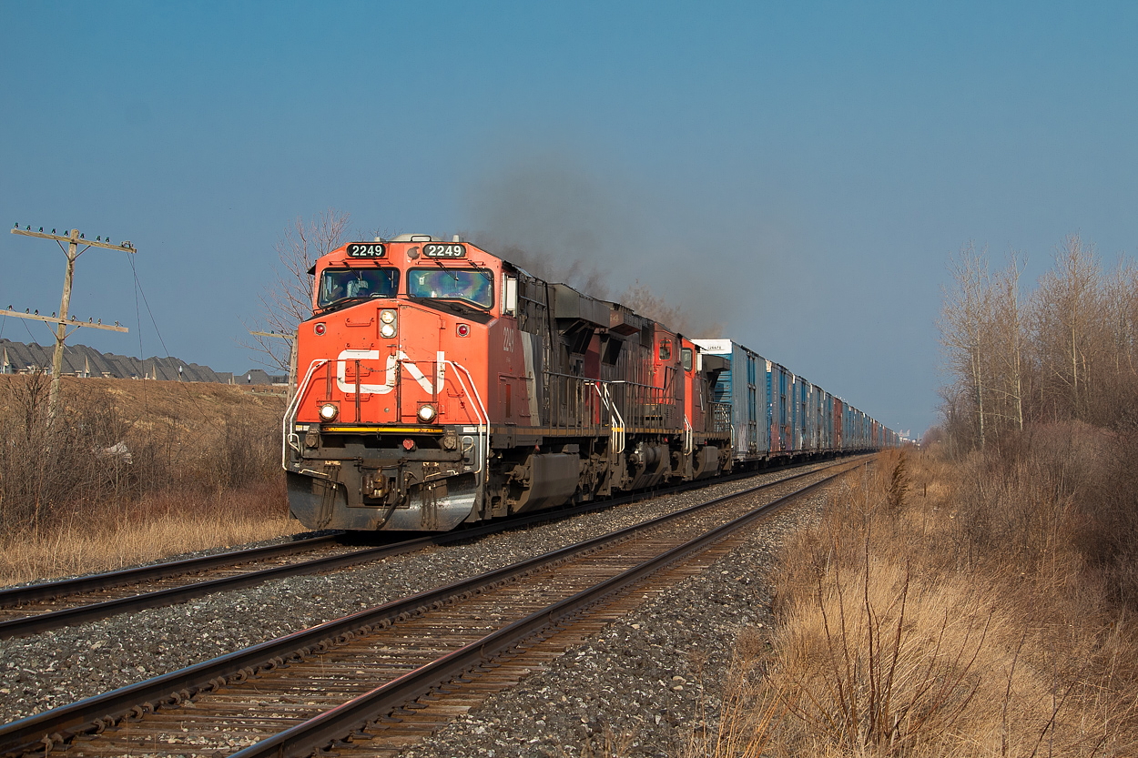 421 was bypassing Stuart after working Aldershot, and I had tried to head it off at the searchlights at Wellington (coming from the far east end of Hamilton's industrial area) only to just miss it. Knowing it was on the south track, and that I had some nice early morning light on the north side of the train, I went out to Fifty Road to try that location for the first time. I sure do love the sight of those auto parts cars on the head end.