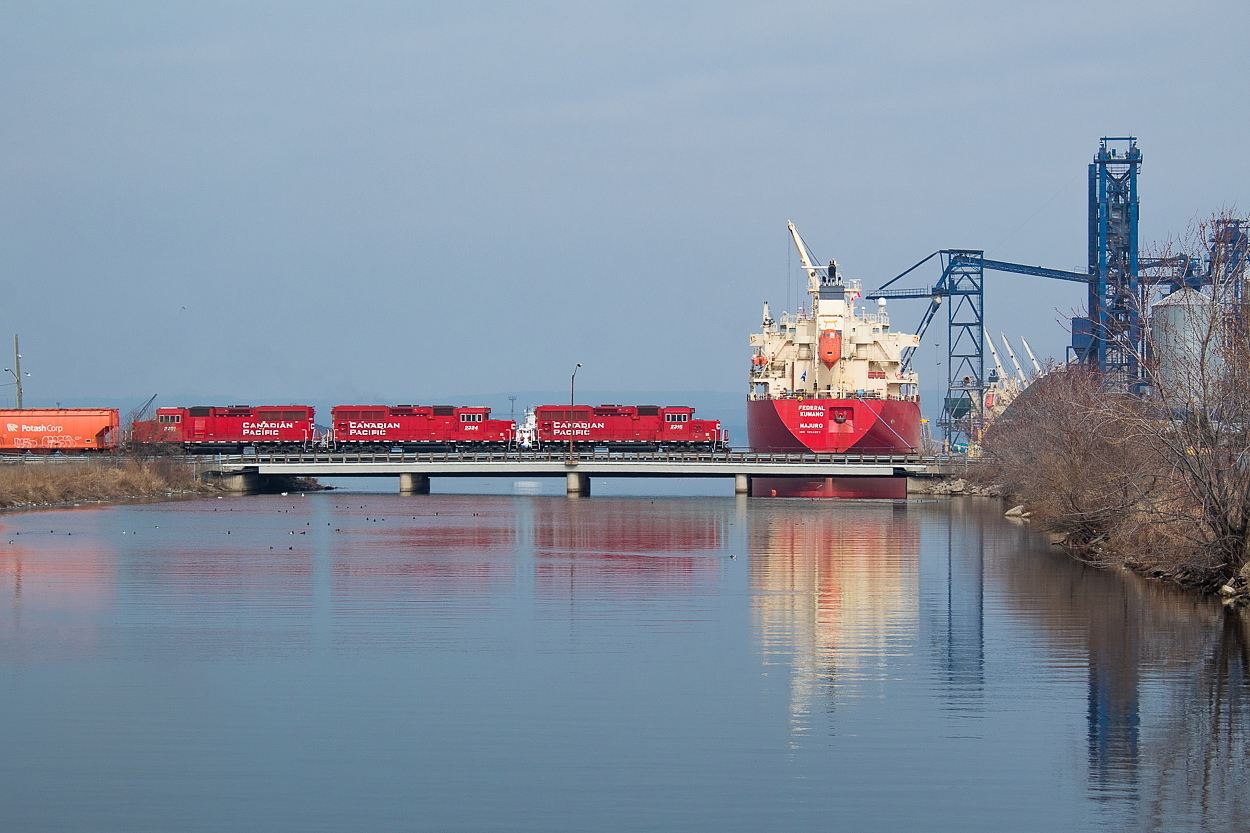 This is a shot I have been thinking about for a while now, and when I saw the potash hoppers leave Kinnear on TH41 this morning I figured today might be the day. The sun was doing its best to fight through the clouds, and I am grateful it was as it certainly helps bring the shot to life a bit. TH41, led by 2316, is on its way over to switch out Agrico in the Eastport area of the Port.