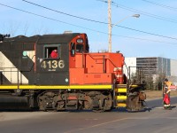 The late day light accentuates the classic GP9 details, as CN local 547 switches out cars on the Glass Lead in Milton. The name of the spur comes from the large glass plant that was served here up until its closure and demolition several years ago. Today the former glass plant site is being redeveloped and there are still a few industries served along the short spur. The brakeman is seen in the process of returning to the cab after flagging a busy crossing, and the train will now head back to the Halton subdivision to complete switching local industries before returning back to Aldershot. 