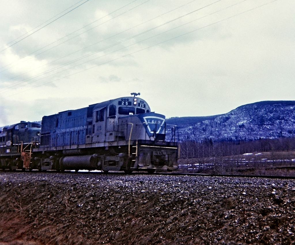 In my opinion and others, this is a truly rare image. In all the the BCR photos I have seen in print and websites I have not seen any thing similar with L&HR units leading on BC Rail in their original paint. Unfortunately it was a dull drab day and Kodak Instamatic was not up to the task.

L&HR 25 leading train #48 a few miles south of Chetwynd, perhaps around mile 649.5. L&HR 25 & 26 were bought by BC Rail and eventually repainted in "two tone green" and renumbered 631 & 632. I never did see L&HR 26 in it's original colors. It was a cloudy afternoon and another one of those Kodak Instamatic moments some 46 years ago.