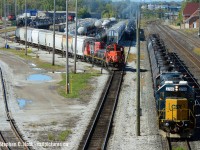 With the Sarnia station at top right, CSX's daily transfer is inbound to Sarnia withh a 12 car train while a CN yard job (Plank rd job?) switches the east end of "C" yard. Top left is the CN Roundhouse and "Bunkhouse" area, which a closer photo from 30 years earlier was posted by <a href=http://www.railpictures.ca/?attachment_id=37211 target=_blank>Mr. Pittman</a> a few days ago. My photo was taken from Indian Rd overpass and gives a great overview of the area with lots of details - a train is also lined west on T2 through the tunnnel. Also notice in far top left the blue/white building? What was it used for? It has tracks leading right up to it... almost looks like an engine or car shop... not quite sure what it was used for now as I don't believe anything goes inside it today.