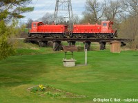 Spring is in the air as a couple of lilys bloom in this nicely manicured backyard complete with a quaint all wood railway trestle. The pair of pups on this day's Cayuga job fit perfectly on the bridge as they head light power to St. Thomas and onward to work St.Thomas, Aylmer, Tillsonburg, and Courtland. The day was mostly cloudy with a few sunny breaks, and the sun came out for me right when it counted and I was thankful for this one to turn out.  You can shoot this pretty scene from putnam road without issue.