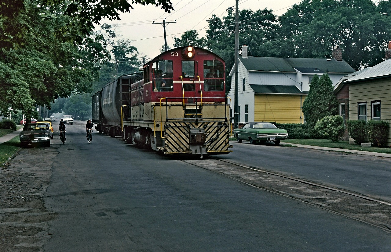 A Ron Tuff photo, posted with permission. Long ago TH&B 53 on Hatt Street in Dundas, Ontario on the TH&B "H&D" branch returning with a couple of loads from Canada Cut & Crushed Stone. Speed limit on the H&D was maximum 15 mph with some other restrictions as well. In my brief time on the TH&B, I had the experience of three trips from Aberdeen Yard out to Dundas on the H&D branch. It was usually the 7 AM, Aberdeen Yard crew that was lucky enough for the trip to Dundas and service the few customers there, Bertrams, Valley City Manufacturing as well as CC&CS "the quarry". The houses in the photo look very familiar but I can't locate them precisely for the GPS location.