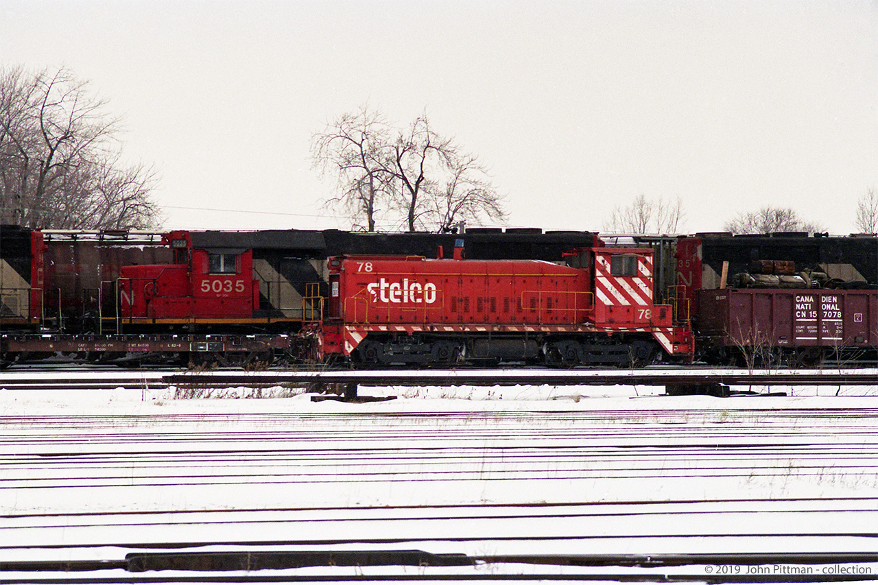 Stelco 78, their first GMD SW900 built May 1956, is seen in CN's London Yard in a winter circa 1995. My 1994 edition of Canadian Trackside Guide lists it among Stelco's locomotives, but by the 1996 edition it's gone. 
Note the black line along the walkway and cab, suspect it's a jumper airbrake hose bypassing the locomotive.  The gondola CN 157078 behind is loaded with looks-like a diesel engine and an AAR-A switcher truck. Another image from the same film strip shows SW8 Stelco 76. My impression is that both #76 and #78 were retired from Stelco at this point.
CN 5035, the SD40 on the track beyond #78, is back-to-back with a similar-looking CN locomotive also ending in "35" (could be CN 5135). 
Location mapped is approximate.