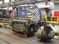 Awaiting new replacements CEFX AC4400 with it's engine on the shop floor and the alternator detached from the block. Note air intakes removed from six of the eight power assemblies on the visible side.