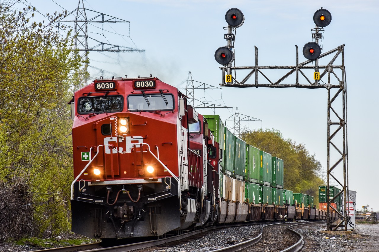 CP train 101 passes the Bartlett Avenue crossing on the beginning of its long journey to Vancouver. The train is seen here on its way up to Vaughan intermodal terminal where it will pick up more cars and change the engine configuration, then continue north. The spring colours are finally showing here in Toronto, and continue to become more vibrant with every passing day.