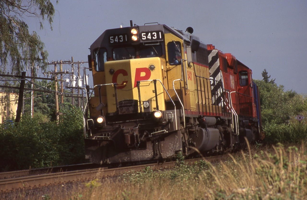 Back when SD40’s were a dime a dozen on CP it was the 5400’s that I usually set my sights on, especially the ones still in their previous owners paint. CP 5431 was the highest numbered former UP unit on the roster and wore this paint until it was sold to NRE in 2005. The unit began life as Missouri Pacific 3197 before being repainted and numbered Union Pacific 4197. It is seen leading an intermodal train westbound at Streetsville in August 1997.