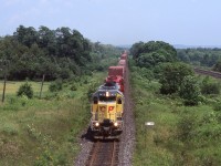 This was one of the few times I caught one of CP former UP/MP SD40’s in the lead, as CP 5429 splits the distant signals just east of Port Britain. A lot has changed here over the years. The yellow SD40’s are long gone as are the signals, which have been replaced and relocated. It’s been a few years since I’ve been out this way and it seems the old wooden farm bridges are disappearing at a fast rate as well, so not too sure if this shot is even still possible today. CN’s Kingston Subdivision can be seen off to the right here as well.