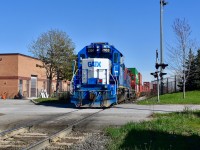 Switching at the north end of CN BIT on a Sunny Sunday afternoon, GMTX 2163 slowly creeps over Ward Road as it leads a stack of intermodal containers northbound along the pullback siding (aka North Park Spur) just far enough where the tail end of the train (right south of the Queen st overpass) can clear the switch to the unloading tracks and the conductor will than realign the switch so the train can back up and spot the containers on the unloading track. Trailing unit was CN gp9rm 7258 in the 15th Anniversary Logo. 