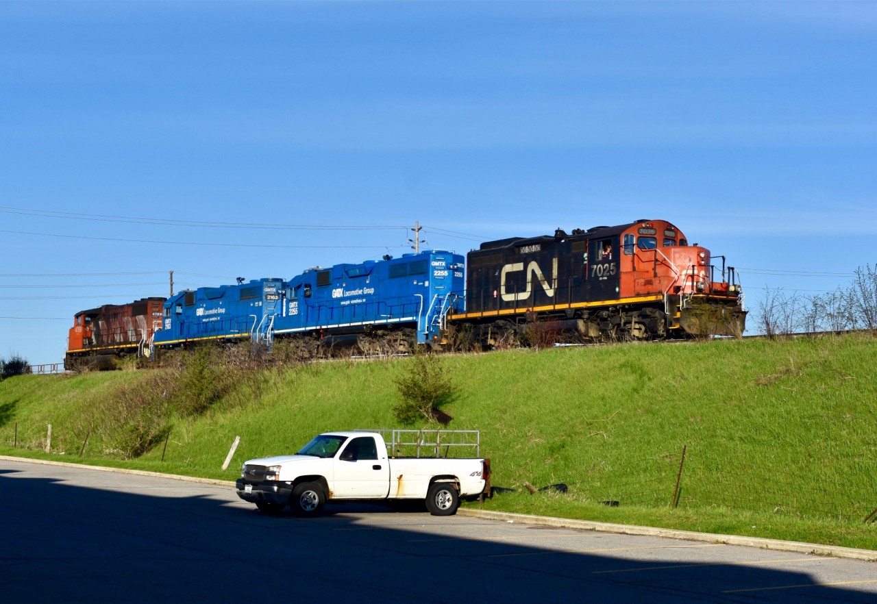 Having just finished its early morning switching duties at the Chrysler Assembly Plant in Brampton, the power of CN L579 is seen paused just west of the Airport Road overpass while awaiting permission from the CN RTC at BIT to run back down the Pullback Siding (against the Yard Tramp using it as a pullback) so they can re-couple on to the loaded autoracks which they pulled out of Chrysler just before dawn (and spotted on one of the yard tracks at BIT). From there they will take the loaded autoracks to Mac Yard and call it a day. Time was 07:25