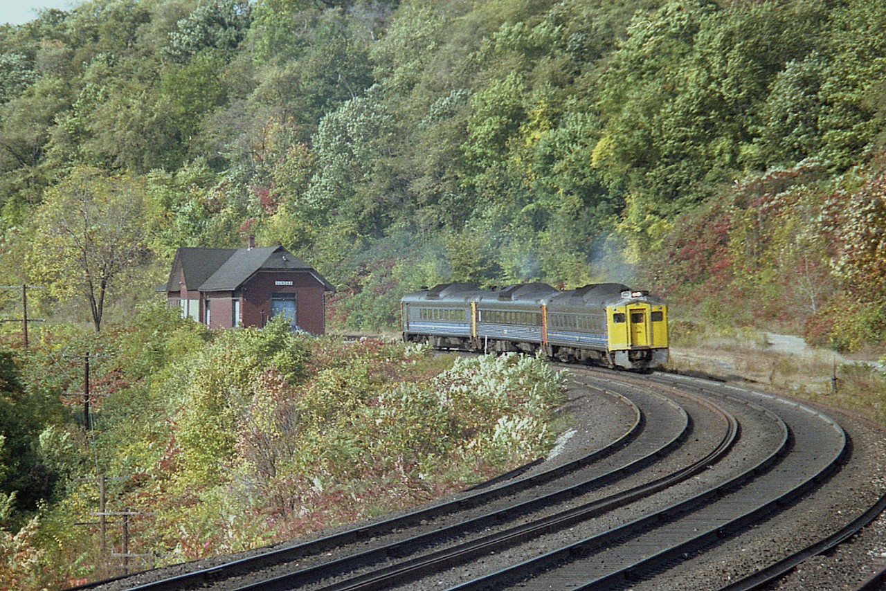 Leaves sure do not show much change as we are into the second week of October. It is a windy and warm, almost summer-like,  morning as the Budds make their way eastbound past the old Dundas station. I had just been returning from a walk up to the Canada Crushed Stone buildings when I happened to see this train in the distance coming down the long grade from Copetown. The RDCs are 6129, 6000 and 6212.