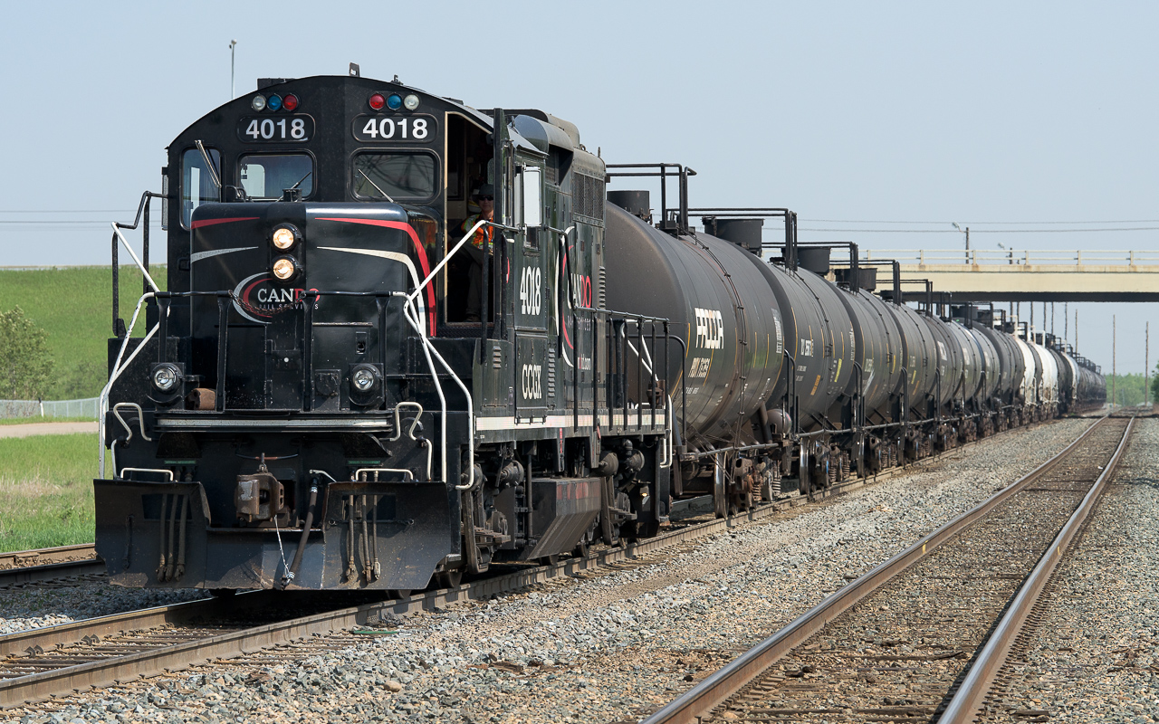 Waiting for a only a few minutes (they got their light right away) in the East Edmonton siding with a string of tanks that will be taken to the storage yard on the outskirts of town. It was a year ago that I last photo'd the 4018, it's still looking great. It was just as hot on that day too, with all the windows and doors open.