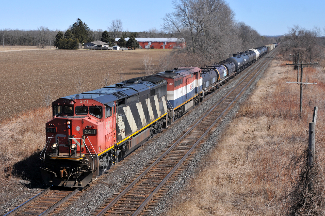 CN 2411 - BCOL 4613 cruise under Blenheim Road with CN M33131 23. They had just completed making a lift of outbound Nanticoke traffic at Paris