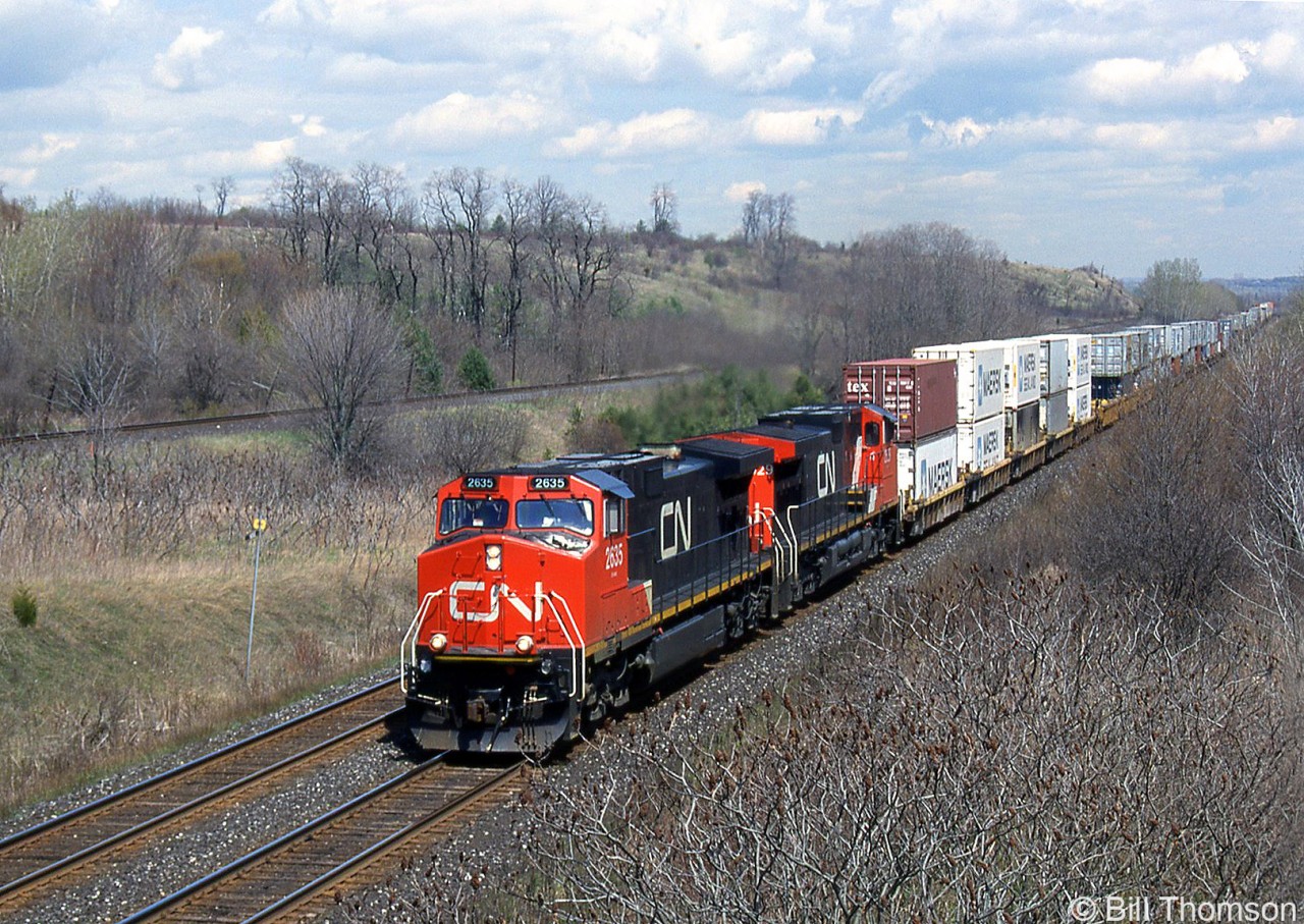CN 2635 leads a westbound intermodal through Wesleyville, at Mile 277 of CN's Kingston Sub. The area west of here is more commonly known as "Newtonville" and CP's Belleville Sub can be seen running parallel in background.