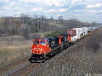 CN 2635 leads a westbound intermodal through Wesleyville, at Mile 277 of CN's Kingston Sub. The area west of here is more commonly known as "Newtonville" and CP's Belleville Sub can be seen running parallel in background.