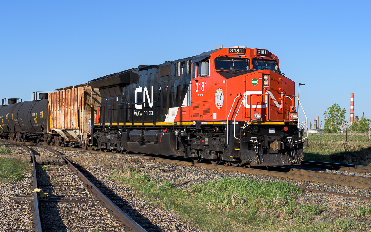 CN 3181 at 7:30 has, only minutes ago, departed Kinder Morgan with the new and improved version of a pipeline. This newer version is not restricted by being buried in the ground. It is portable and can be rolled to many rail destinations. The 2801 is helping out on the rear. The 3181 is still looking pretty fresh, just a few splatters along the bottom edges.