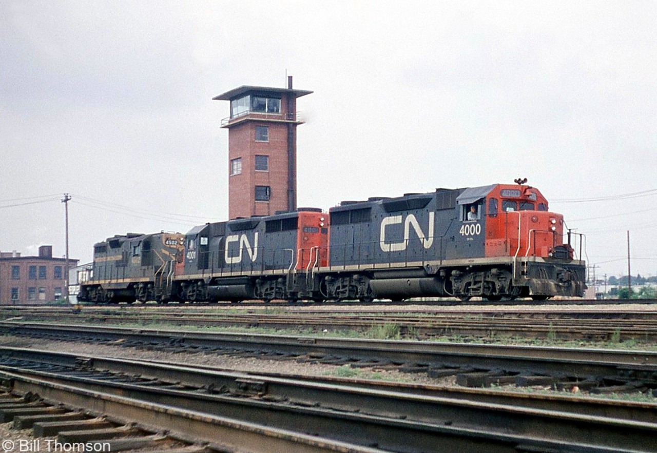 CN GP35's 4000 and 4001 are coupled with GP9 4502, moving around as light power at Mimico West. The yard tower at the west end of Mimico Yard is visible in the background, located between Canpa Tower and Kipling Avenue. There was another tall yard tower in Mimico near the east end of the yard.

Both GP35's pictured were the only two units of that 2500hp model CN purchased, built by GMD in 1964 (and later renumbered 9300 & 9301). They would remain orphans as CN's subsequent 4-axle GP purchases from GMD would be the upgraded and more powerful GP40 model (4002-4017), and later on various groups of 5500-series GP38-2's and 94/95/9600-series GP40-2LW's.