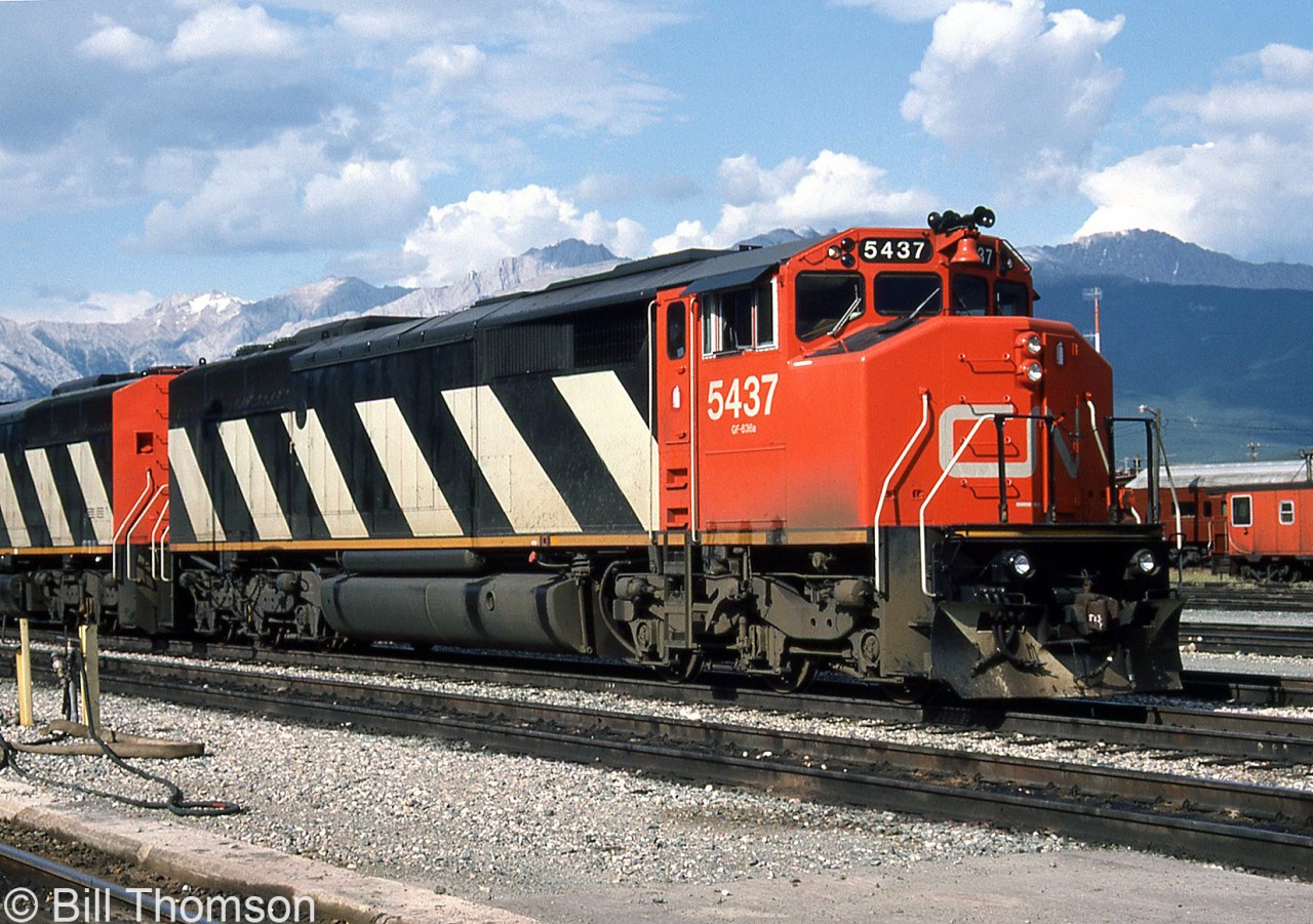 CN SD50F 5437 is shown with a sister unit at Jasper AB in July 1986, a little less than a year old.

5437 was one of 60 units manufactured by GMD London between 1985 and 1987 for CN based off the standard SD50 model, but with a full-width enclosed cowl body and a "Draper Taper" behind the cab for rearward visibility (named after the employee at CN who designed it). This design first debuted on CN's Bombardier HR616 order in 1982, and over the years CN would go on to order GMD SD50F, SD60F, and GE C40-8M models with this feature, until switching back to orders with conventional hoods in the mid-90's. The SD50F fleet would run until 2008 when they were retired. Some would be resold to a short line, but most were sold for scrap.