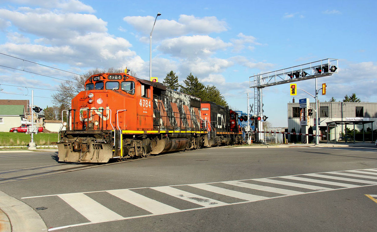 On May 5, 2019, CN 568 ran to Stratford then upon return to Kitchener, did a run down to the interchange to drop off the cars from Stratford. The northbound run in the spring/summer evening offers some good photo ops so I had to take advantage of the nice light. It is pictured at the Ottawa and Mill St. intersection heading back to Kitchener Yard light power as CN 4784, CN 7068 and GMTX 2264. The far tracks are the LRT line, with the Mill St. station out of sight behind the power.