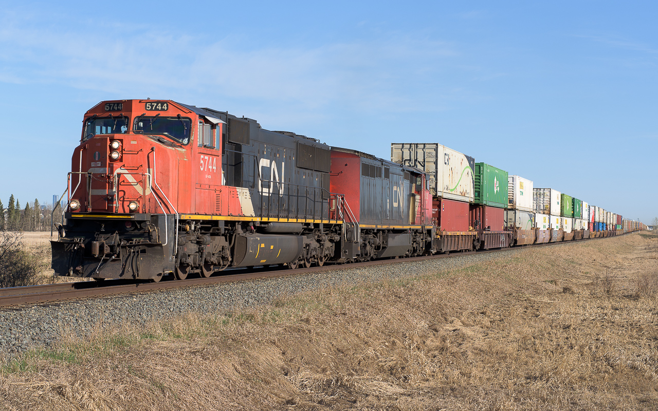 CN 5744 and CN 2453 are just leaving the outskirts of Edmonton at 8:30. It's a beautiful day to be heading out for Mirror, Alberta.