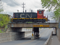 In behind me, CP TH-31 crosses Kenilworth Ave, arrives at NSC to pick up their lift for the day. The CN 1500 yard job (I assume) is heading east across the N&NW (correct me if I'm wrong) after shuffling a bunch of cars in the meal yard at bungee and will cross Kenilworth between me and the CP at NSC. Stealing the show is CN 7304, one of less then a handful of SW 1200RSs still active on the CN roster, crossing above Kenilworth at the west end of Parkdale yard. Despite the holiday, all hands are on deck in the heavy industries in Hamilton's north end. 