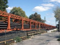 A long line of specially modified flatcars on a CN Continuous Welded Rail train are seen loaded with new welded rail, pictured just east of Brantford station on the CN Dundas Sub. 