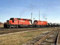 One of CP's "Acid Trains" rolls through Guelph Junction heading westbound past the station (note the station train order board signals behind the train), lead by SD40-2 5788 with white extra flags and class lights illuminated, followed by M630 4508 trailing.