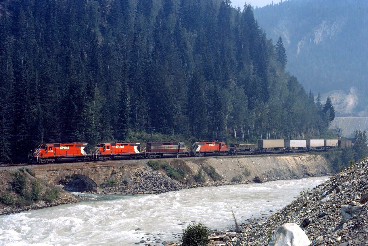 Four SD40s (CP 5559, 5545, 5541, and 5504) lead a westbound alongside the Kicking Horse river at Glenogle, BC; Golden is about 7 miles ahead. The third unit--5541--was the last SD40 to wear the maroon and gray paint scheme.