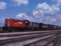 In the summer of 1970, the CP Rail image was just starting to appear on motive power and rolling stock. Here we see an RS18/RS18/FPA2 (8738, 8743, 4093)lash-up representing the "new" and the "old" paint schemes, leading a westbound extra freight through Guelph Junction on a July afternoon.  