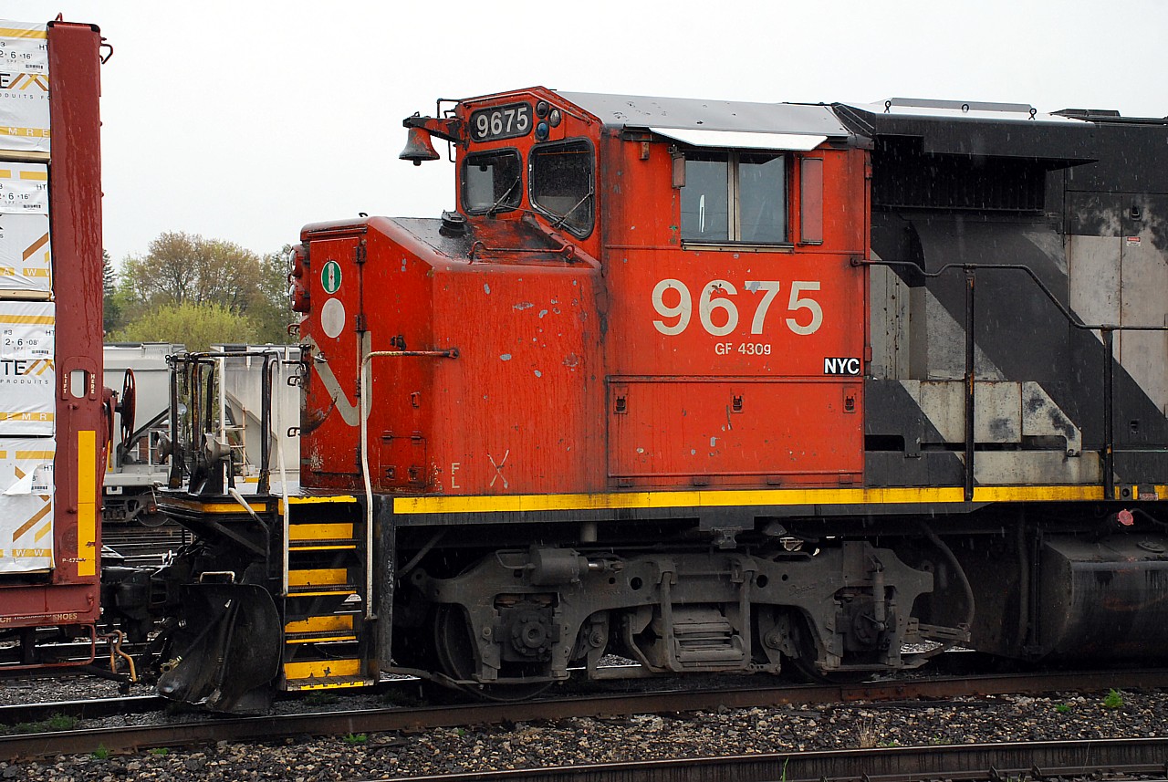 Former CN 9675, now sub-lettered NYC, is the fifth unit on 580 resting in the rain while the crew takes a lunch break.  Could this be the first sign of a forthcoming merger between two Hunter Harrison legacy railroads?  Will the GP40-2L(W), built new as GO 708, soon wear CSX blue/yellow?  Oh the excitement!