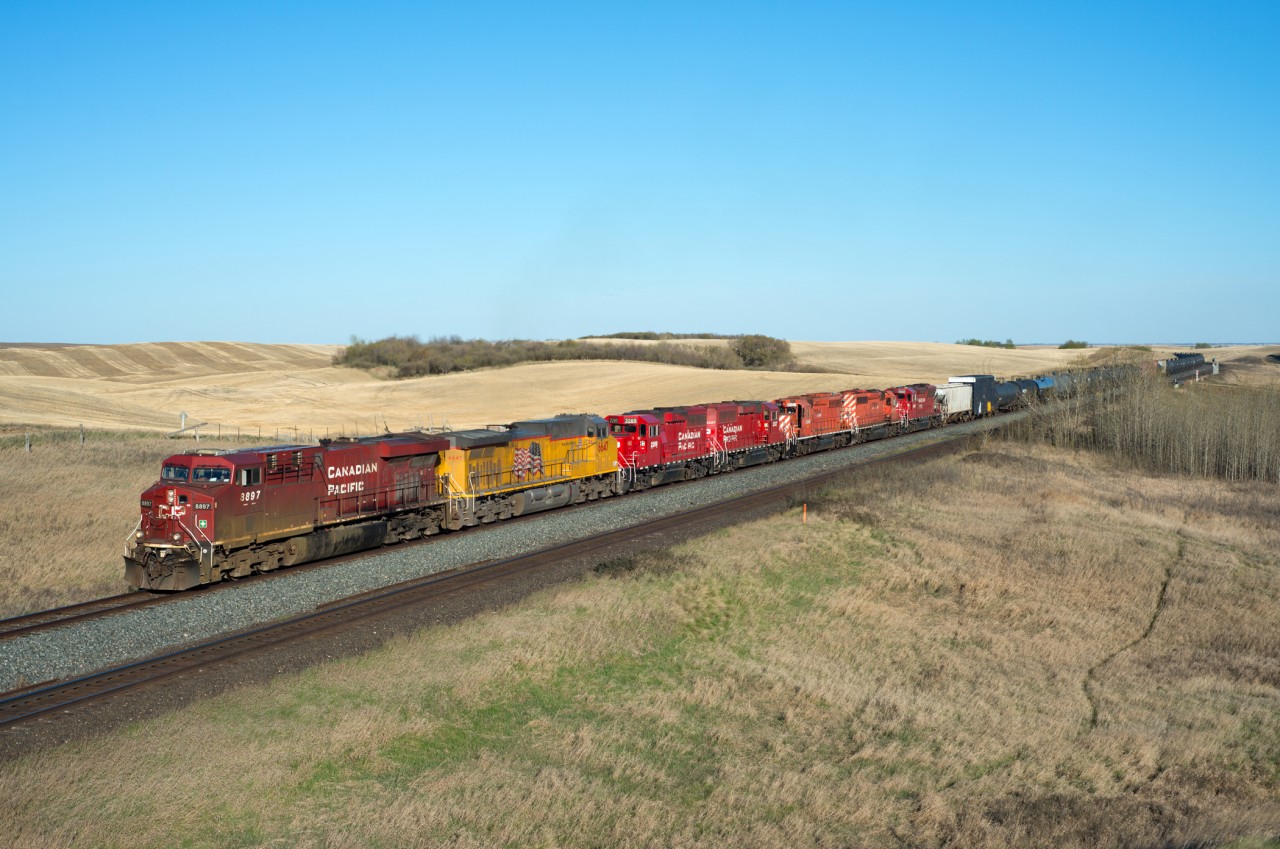 CP 463 makes its way west through Keppel on the Wilkie Sub. The track in the foreground is the busy CN Watrous Sub which was just a minute or two away from throwing an eastbound in-between this sweet consist and yours truly. 

For the number guys, 8897,UP6647,2289,2227,5946,6030,5042 the trailing five units were set out in Wilkie.
