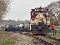 The conductor climbs aboard as GP9u's 1620 and 1591 shove a cut into the Lower Yard.