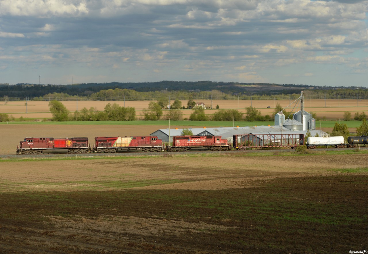 CP 9780 North approaching Baxter on a clear to stop with 421's freight after lifting 2 cars @ Spence, they'll get a light shortly and blast off with 5 cars (behind 5) to set off @ Midhurst and a clearance to Mile 100 MacTier sub in hand. 3 different engine models with 3 unique looks, you've gotta love that CP variety!