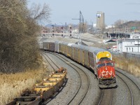 SD75I CN 5738 is the sole power on CN 401 as it rounds a curve on CN's Montreal Sub, passing underneath a set of signals that were installed last year.