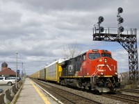 CN 368 passes underneath a classic signal gantry at Dorval just before the clouds rolled in. Power is CN 3063 up front and CN 3118 mid-train on this 137-car train.