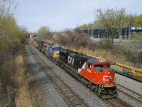 The power on CN 120 is usually comprised of mostly GE AC units, but it had some nice variety today, with CN 8898, GECX 7703 and CN 5667 up front and CN 2282 mid-train. Here this 624-axle long train rounds a curve near Turcot Ouest.