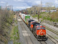 CN 3031, CN 3144 and CREX 1508 are the head-end power on CN 120 (with CN 3106 mid-train) as it exits Taschereau Yard, bound for Halifax.