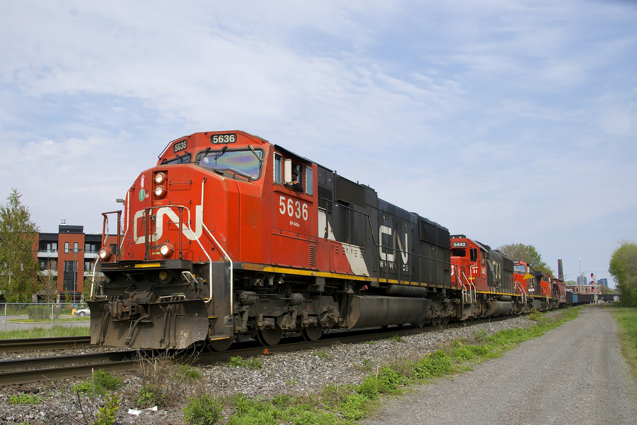 CN 527 with 4 units (CN 5636, CN 5442, CN 2666 & CN 9547) and a short train heads west on the south track of CN's Montreal Sub. After working Pointe St-Charles Yard, it is headed to Taschereau Yard.