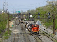 With CN 310 stopped on the north track up ahead at Turcot Ouest to change crews, CN X308 is crossing from the north to the freight track at Ballantyne (it will change crews there as well). CN 2125 is the sole power on this train of empty flats, heading back to the QGRY for more windmill towers.