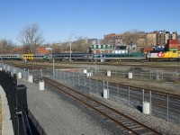 Still wrapped for VIA Rail's 40th year anniversary (2018), VIA 6437 leads a 5-car VIA 22 past Pointe St-Charles Yard.