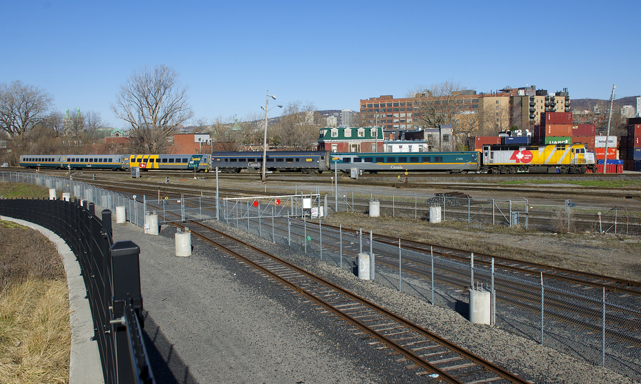 Still wrapped for VIA Rail's 40th year anniversary (2018), VIA 6437 leads a 5-car VIA 22 past Pointe St-Charles Yard.