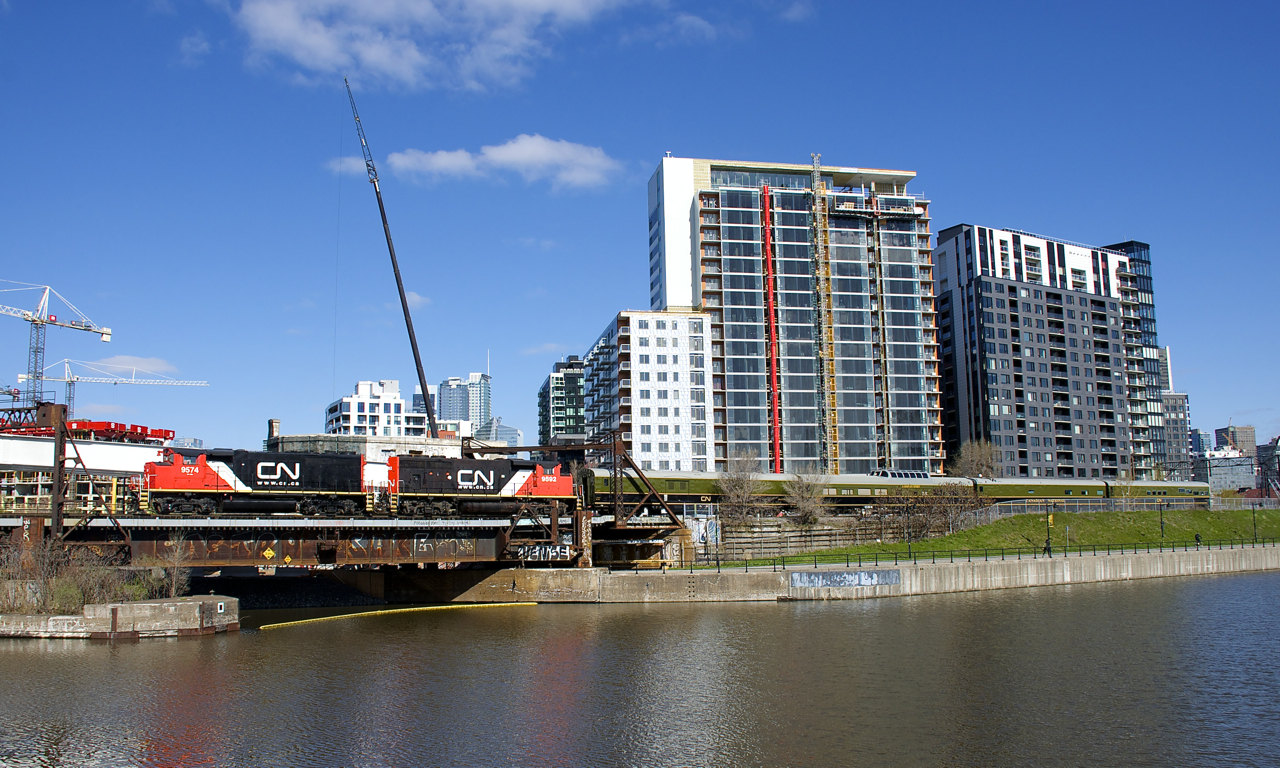 Spotless GP40-2L(W)'s CN 9574 & CN 9592 lead 4 CN passengers cars as a special train promoting activities for CN's 100th anniversary leaves Montreal, en route for Quebec City. Soon a CN 100 train will be touring North America.