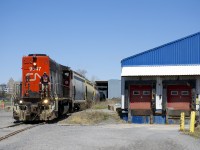 The Pointe St-Charles Switcher is leaving the P&H mill with six grain empties with CN 9547 running long hood forward as it approaches the Bridge Street crossing.