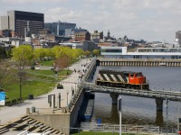 After bringing a long transfer into the Port of Montreal, CN 9547 is leaving light power as it crosses a bridge over the eastern end of the Lachine Canal.