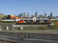 The combined VIA 601 and VIA 603 passes the Pointe St-Charles Yard, where recently coupled GP9's CN 7075 & CN 7229 idle before making their next move.