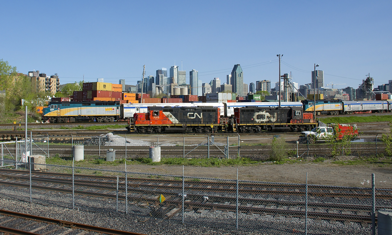 The combined VIA 601 and VIA 603 passes the Pointe St-Charles Yard, where recently coupled GP9's CN 7075 & CN 7229 idle before making their next move.