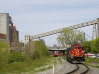 Grain infrastructure is visible in the background as GP9's CN 7075 & CN 7229 head east to pick up empty grain cars on track PC-27.